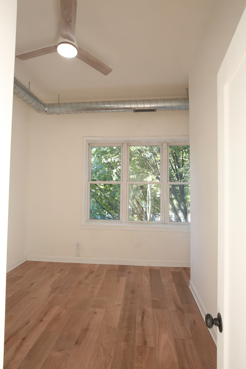 1077 W Polk #2 — front bedroom with large windows and tree views