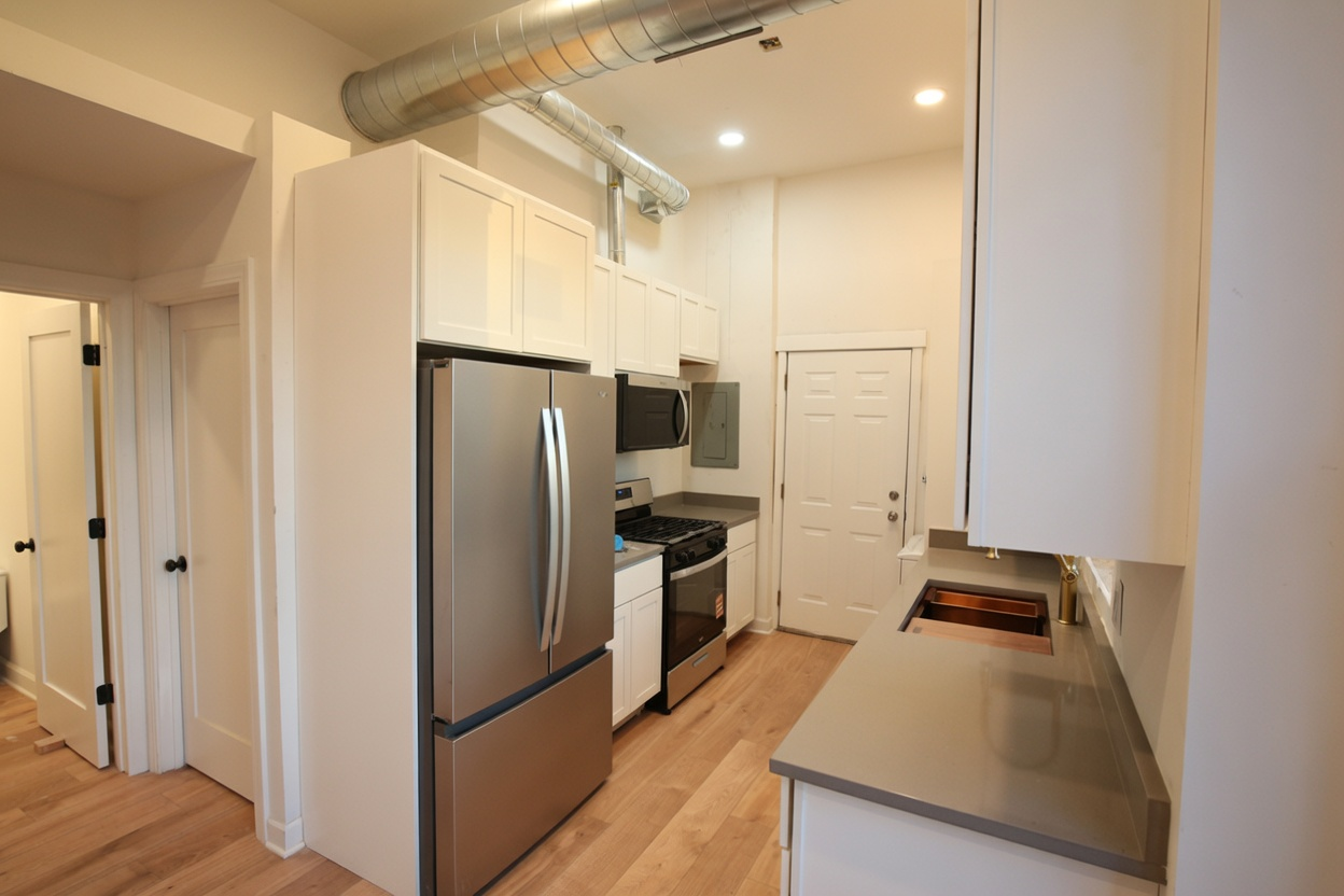 1077 W Polk #2 — full kitchen with stainless appliances and white cabinets